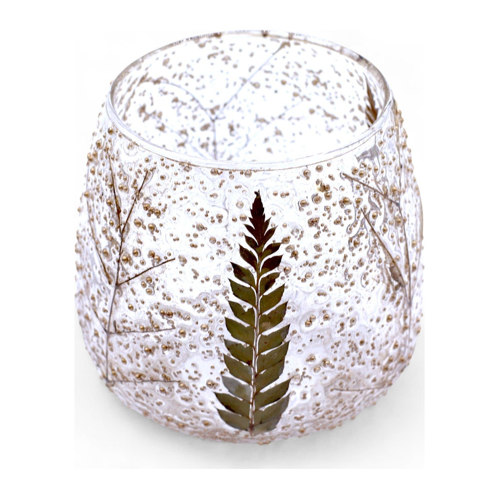 Clear textured glass candle holder with fern leaves preserved inside