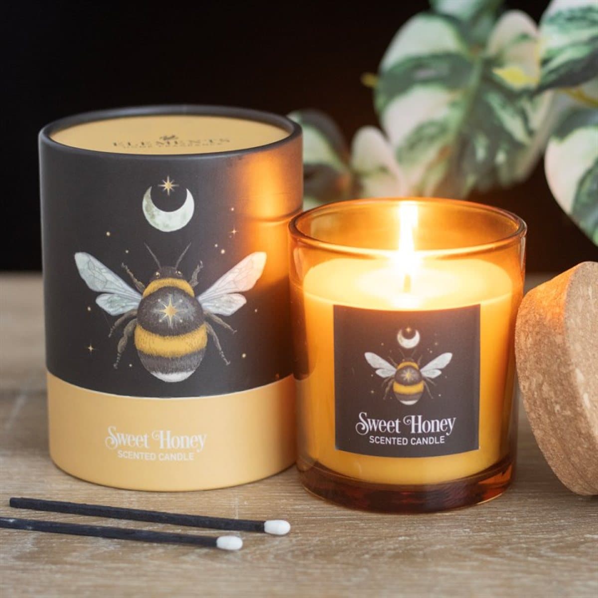 Sweet honey candle in a glass holder with cork lid and forest bee design