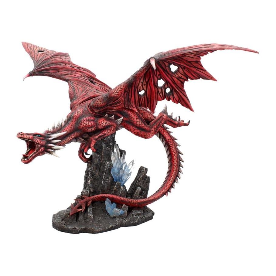 Red dragon figurine on black rock with blue crystals, wings raised and mouth open