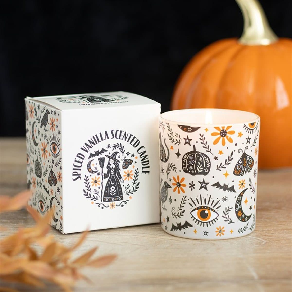 A spiced vanilla candle in a printed folk-design glass jar