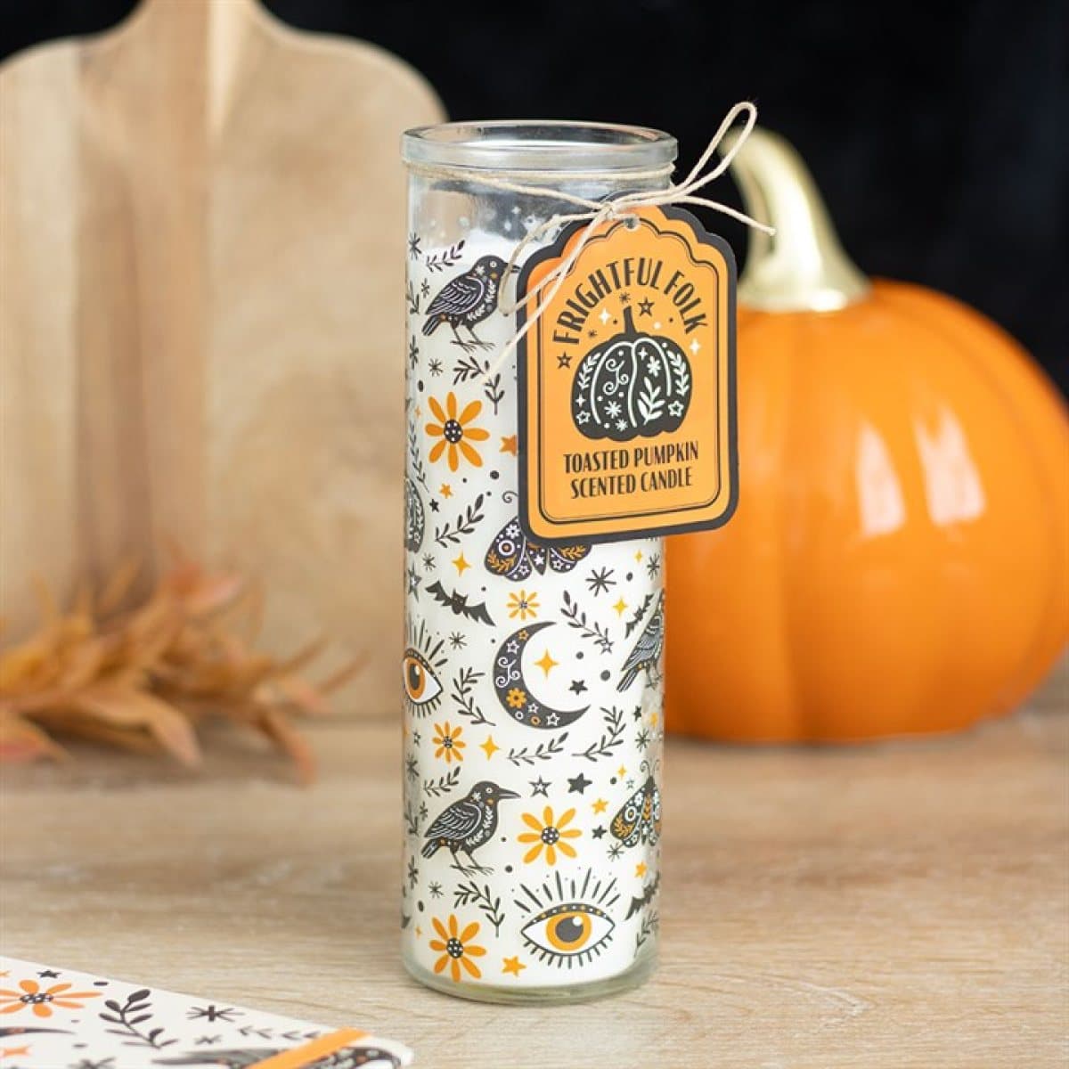 Tall glass tube candle with a folk-inspired print