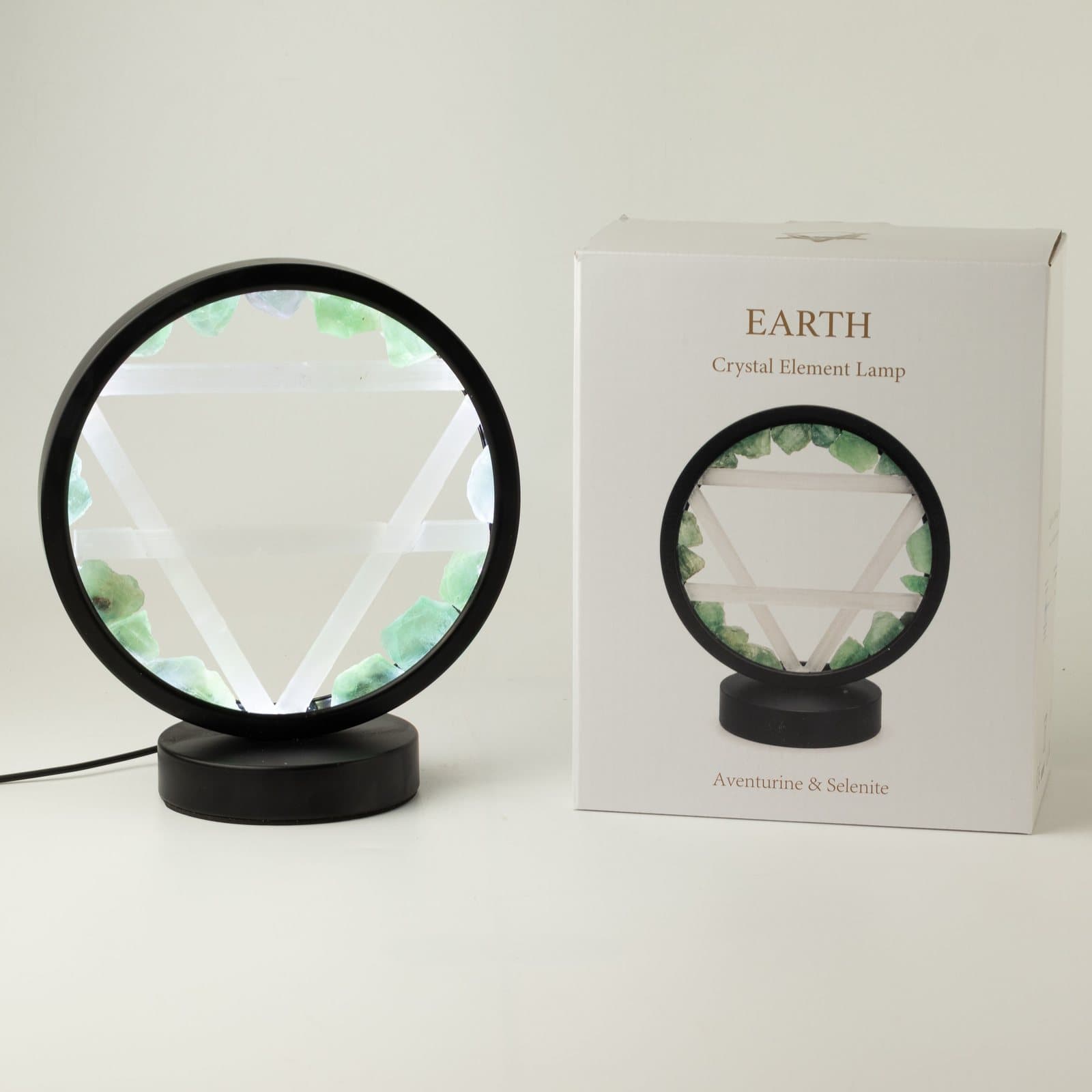 Round black lamp edged with green aventurine, selenite Earth symbol in the centre