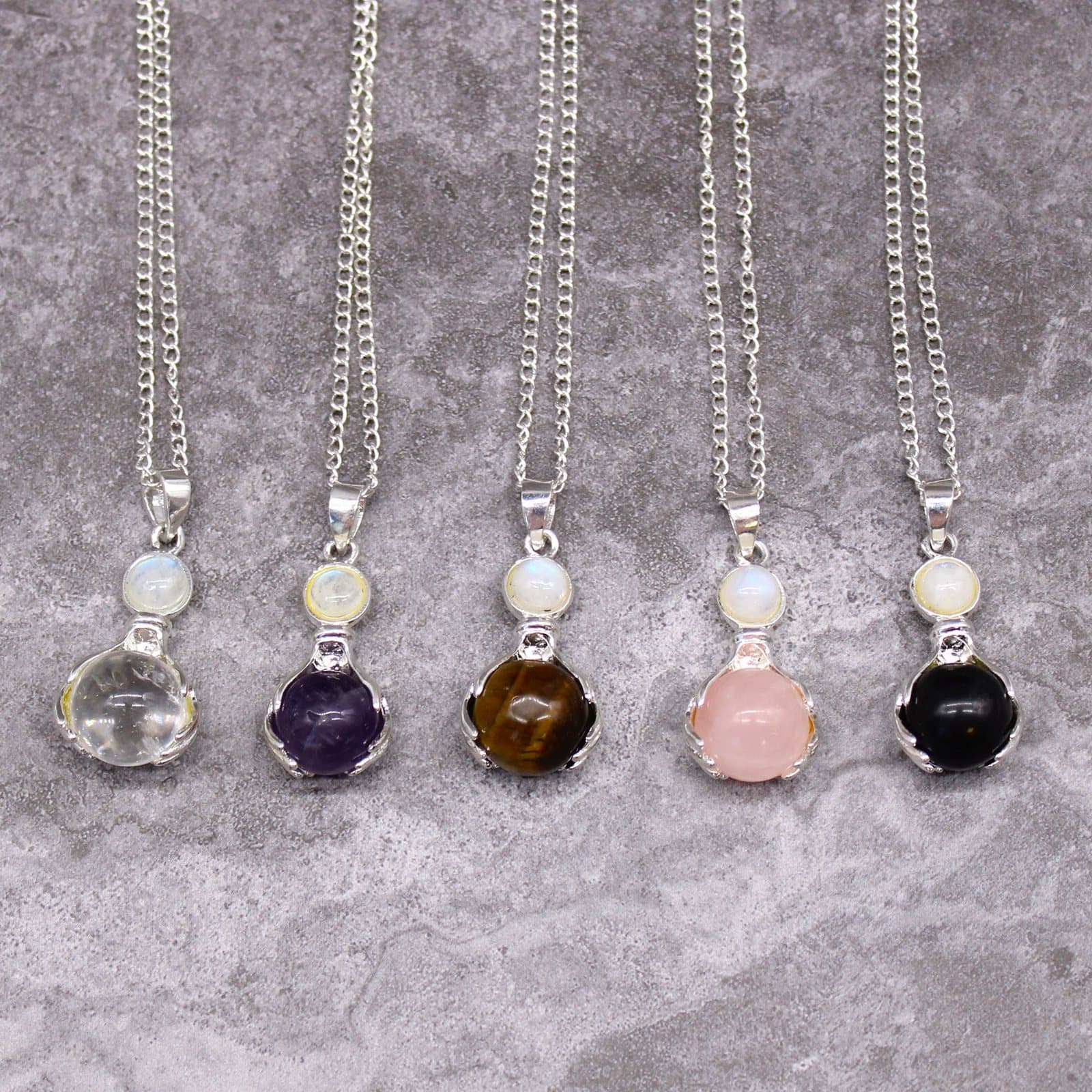 Rock quartz pendant with a hands design and silver-plated chain