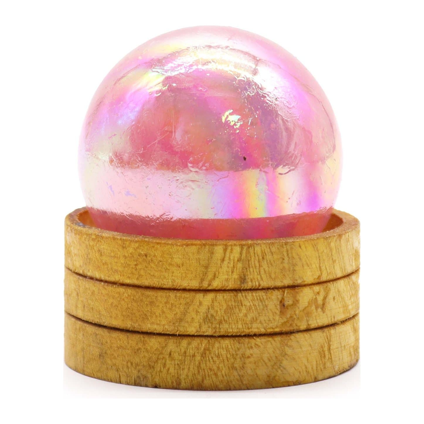 Rose quartz titanium aura crystal sphere resting on a stand