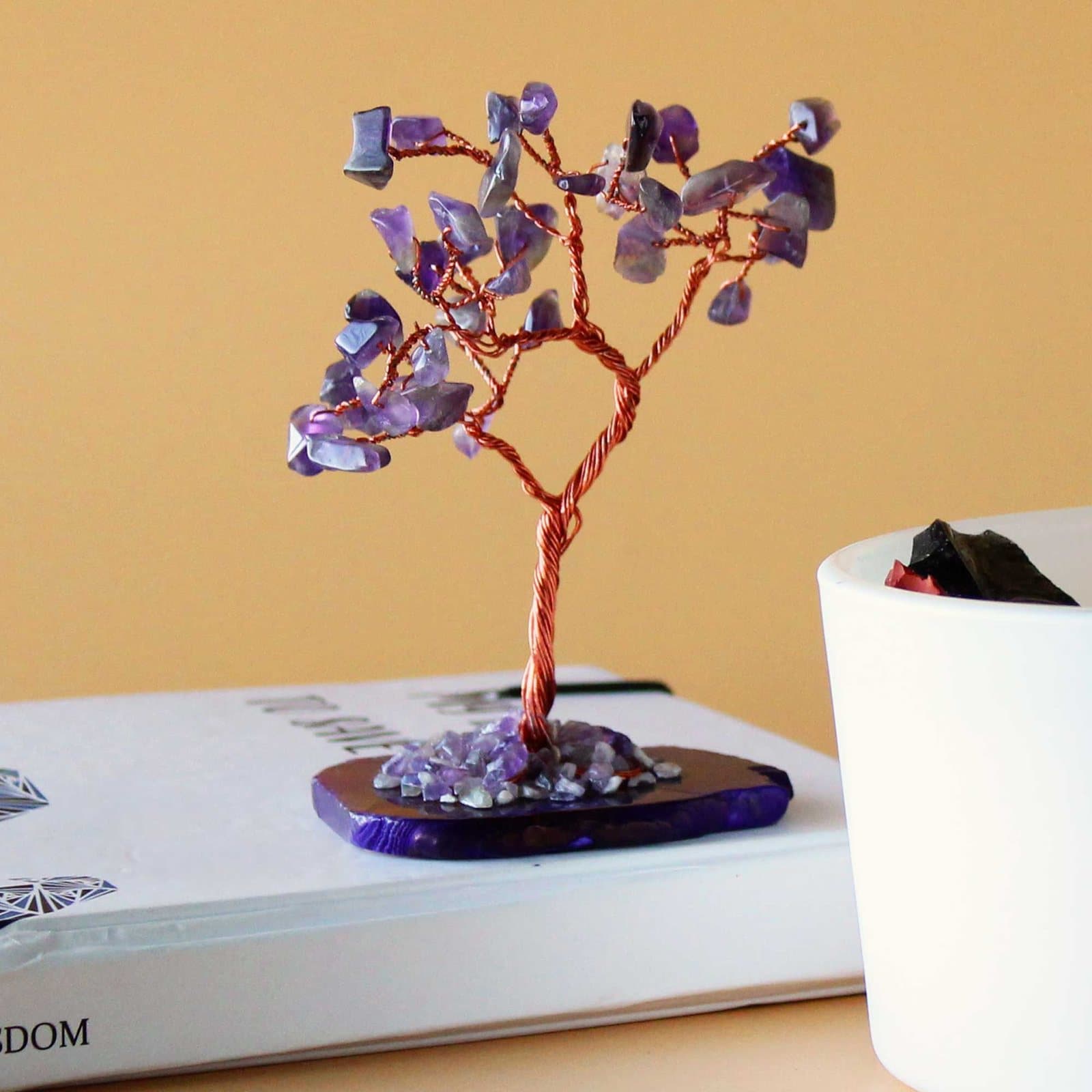 Small tree of purple amethyst stones on an agate base