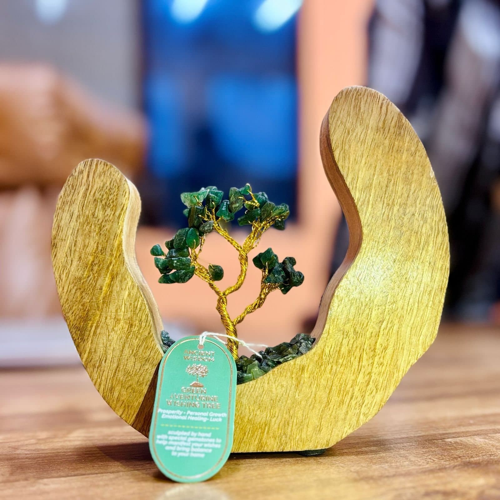 Gemstone tree of green aventurine chips in an open mango wood ring