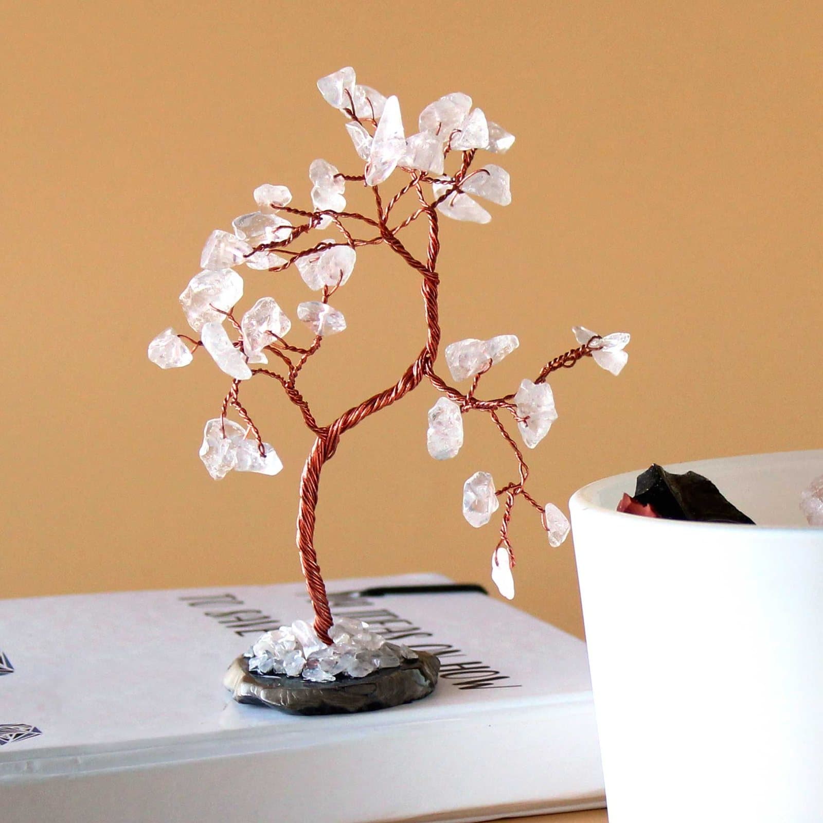 Gemstone tree of rock quartz stones on a black agate base