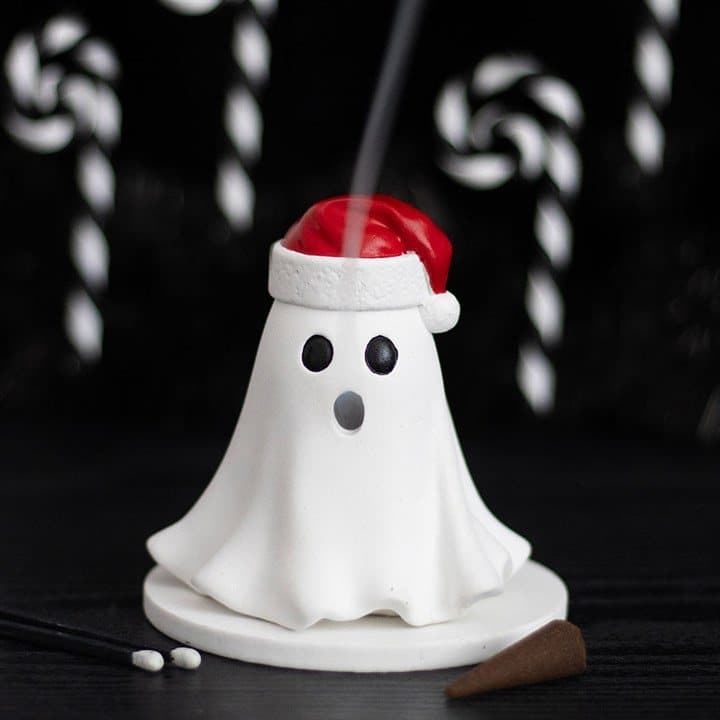 Ghost-shaped incense cone holder wearing a Santa hat
