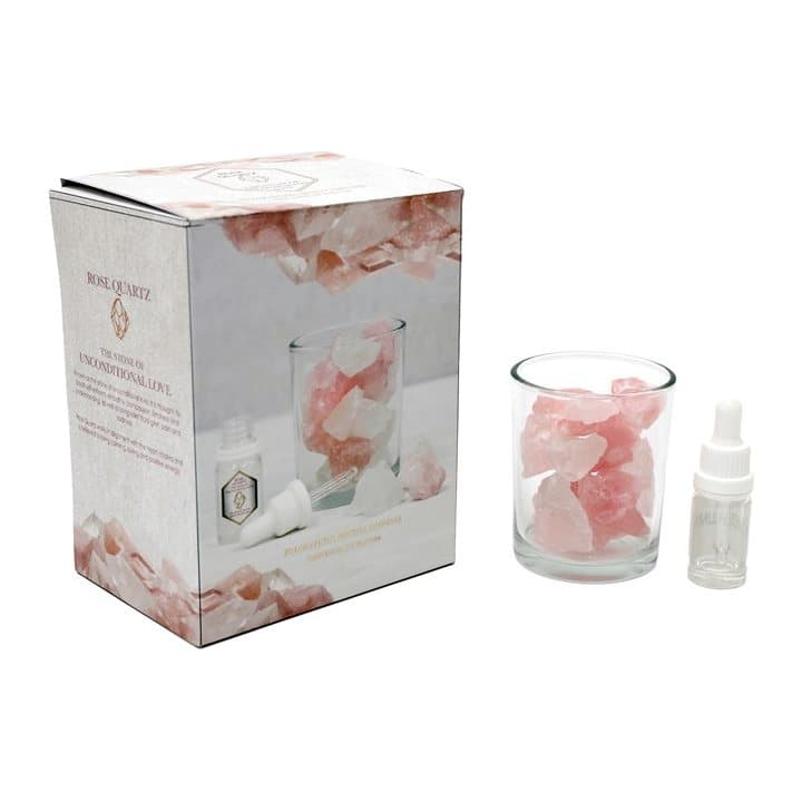 Glass jar of rose quartz crystals with fragrance oil