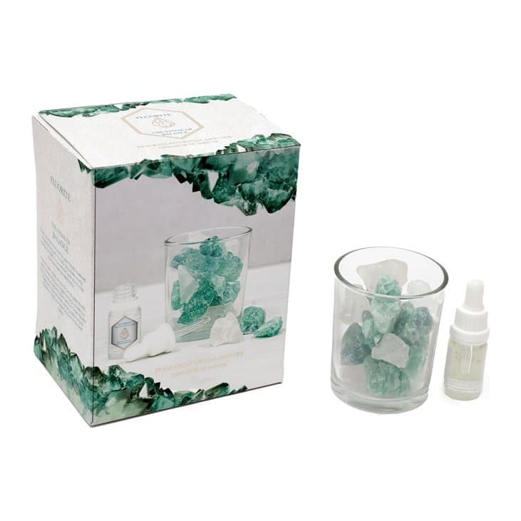 Glass jar of green fluorite crystals with lid and fragrance oil
