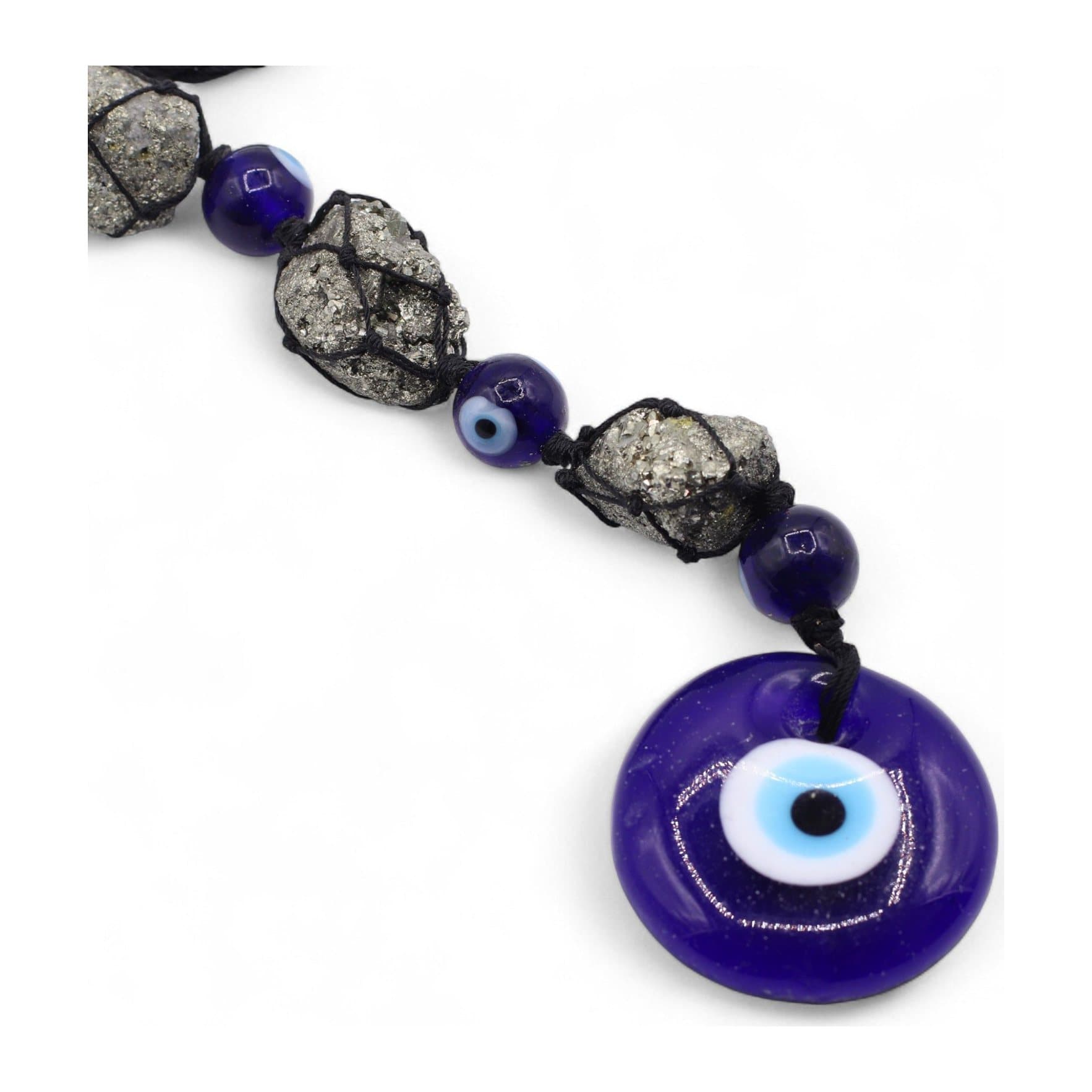 Hanging pendant with pyrite stones, deep-blue glass beads and an evil eye