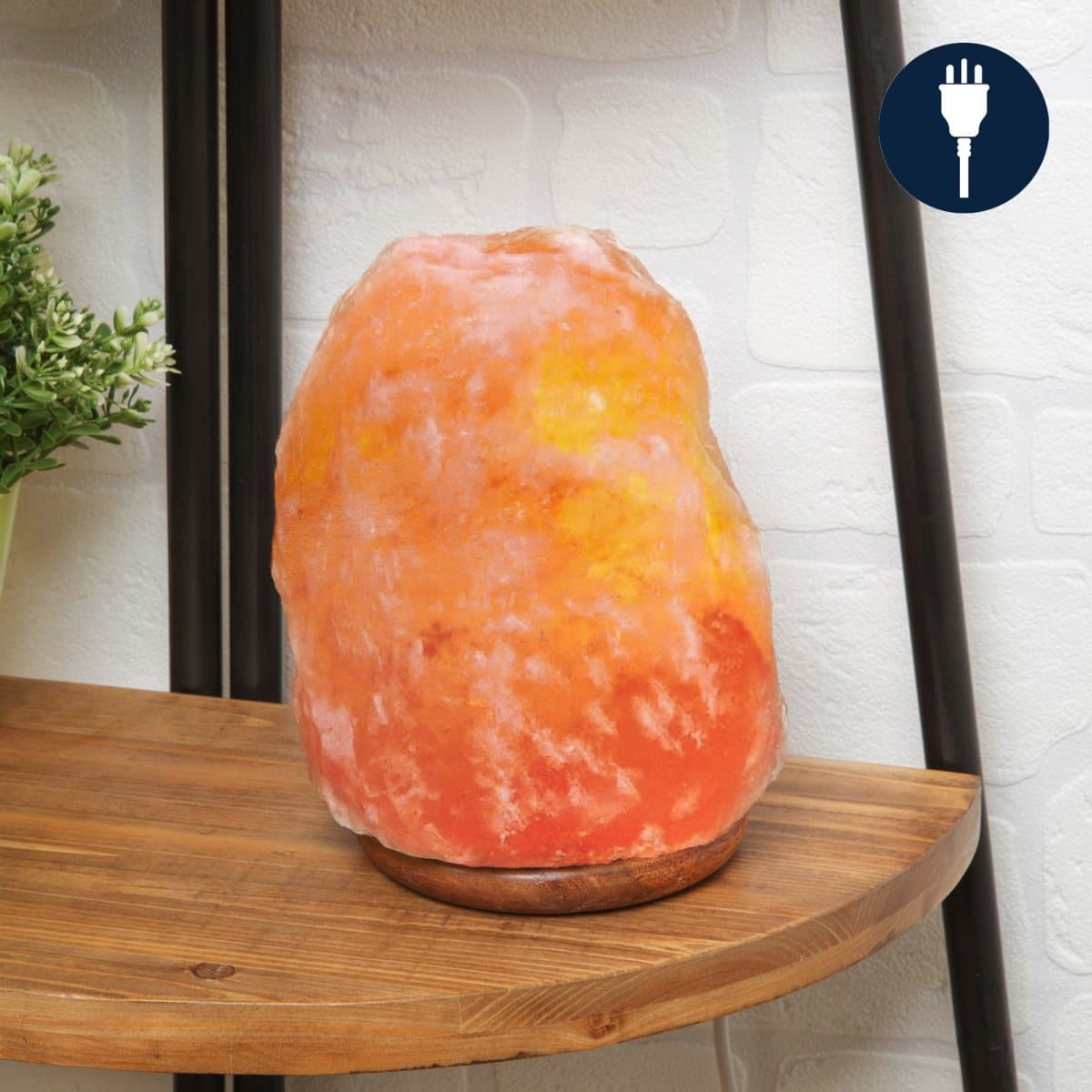 Hand-carved pink Himalayan rock salt lamp glowing red and orange
