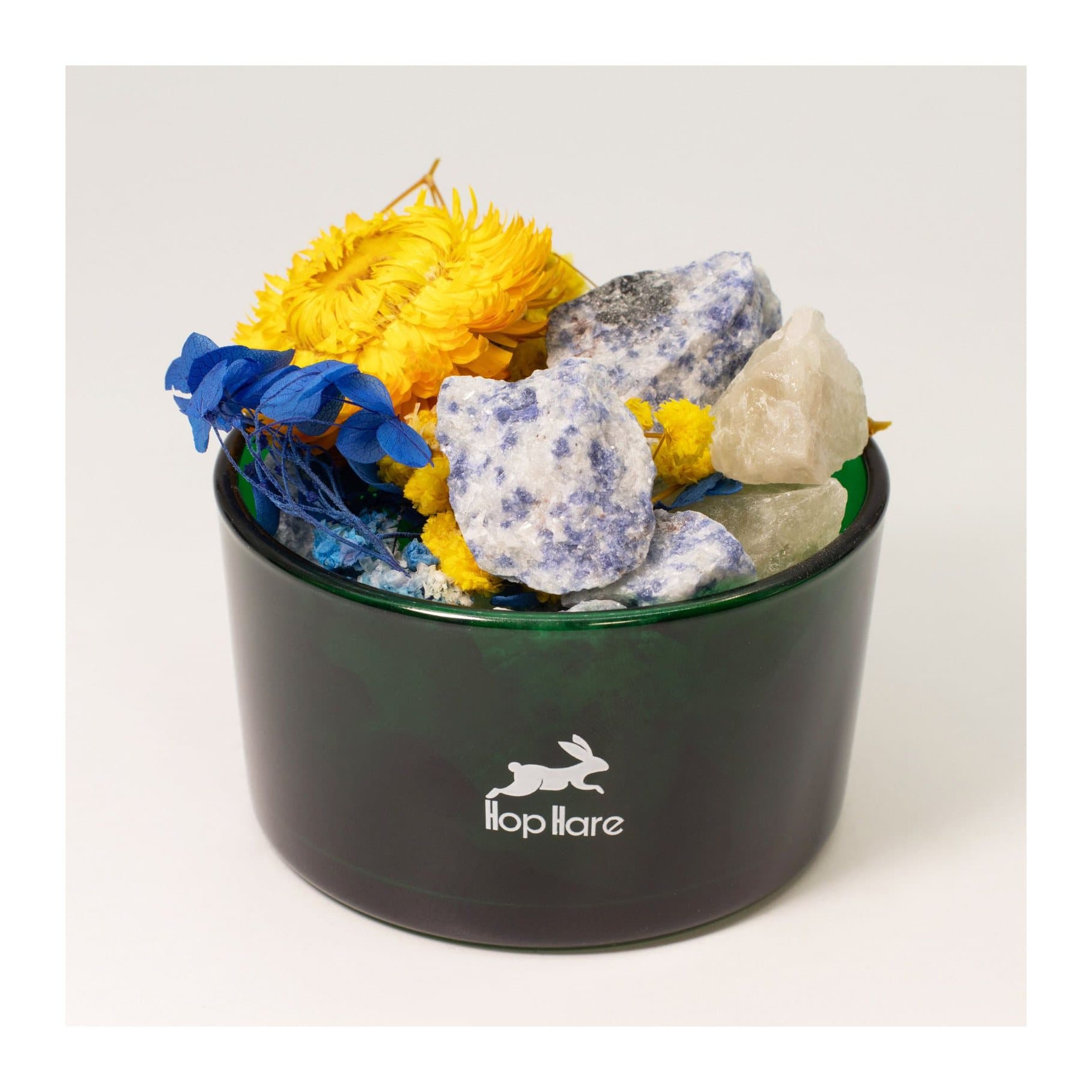 Sodalite crystals arranged with brightly coloured dried flowers