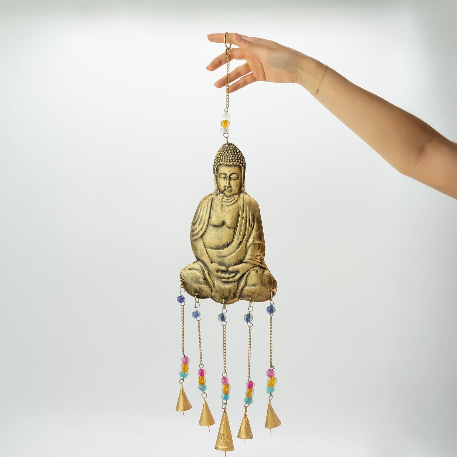 Indian wind chimes with brass bells hanging from decorative designs