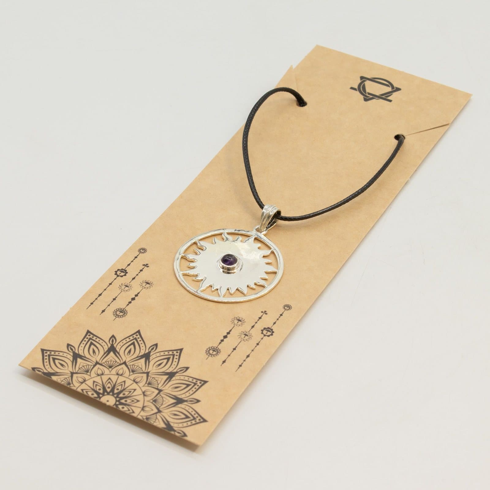 Silver-plated sun pendant with a purple stone on a black cord