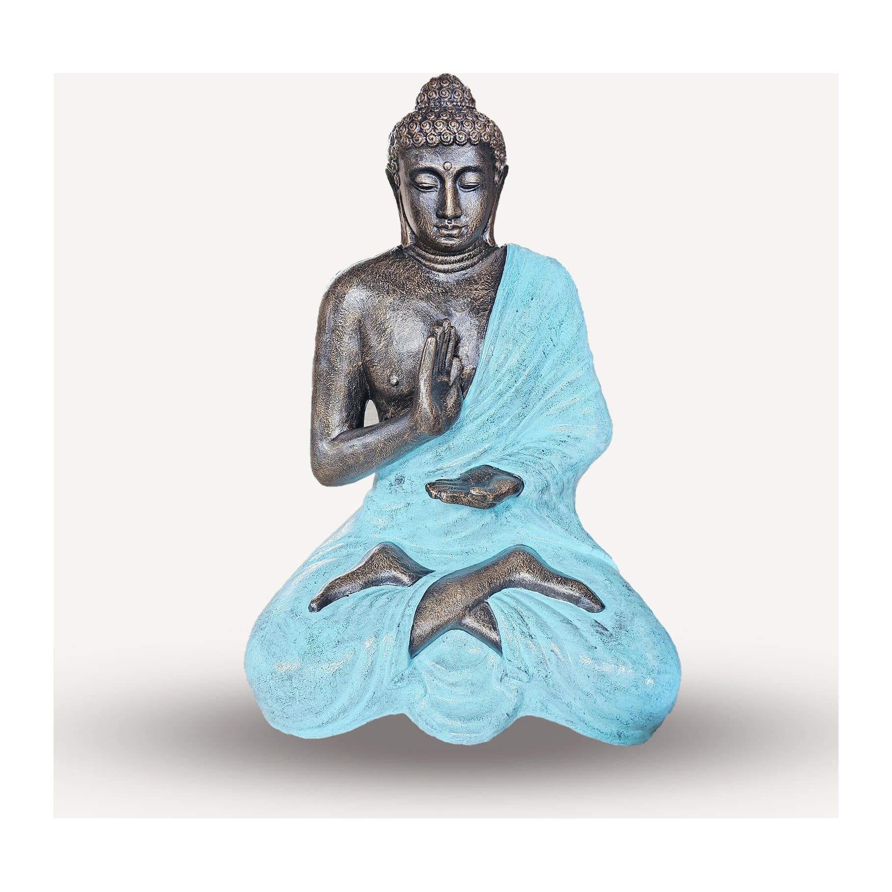 Large turquoise and stone statue of the Buddha meditating inside a stupa
