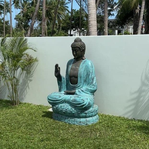 Large turquoise and stone Buddha statue teaching on a lotus