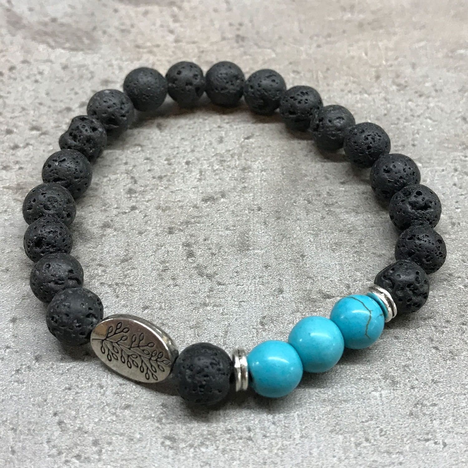 Stretch bracelet of dark lava stone and gemstone beads