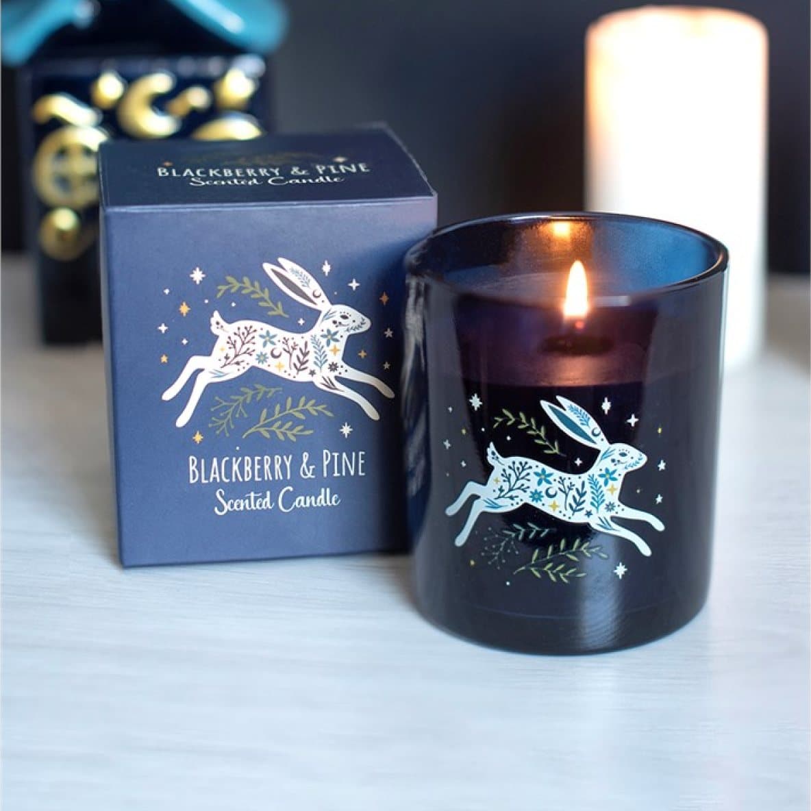 Blackberry & Pine scented candle with a moonlit hare design and its colour cardboard box