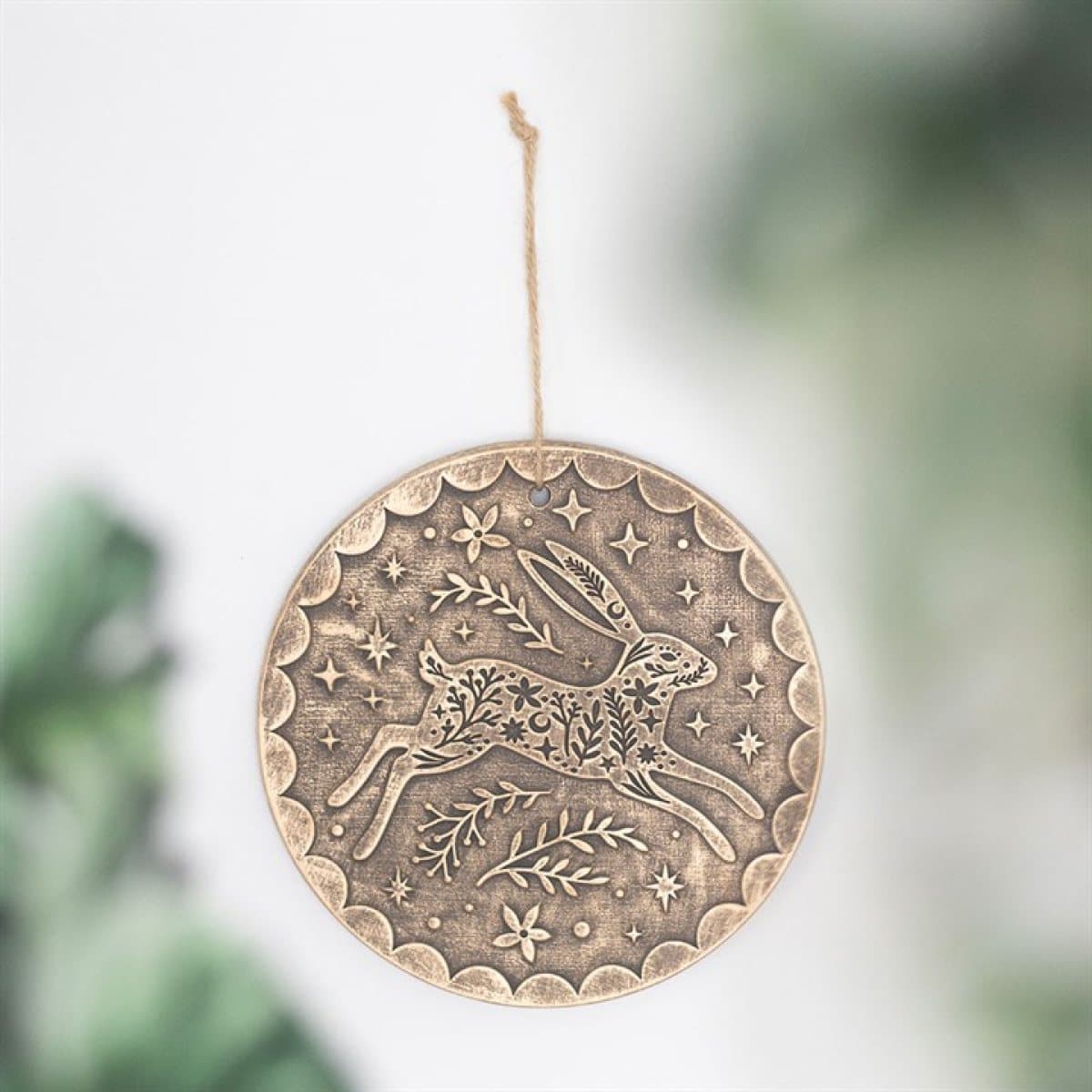 Terracotta plaque with a leaping hare and botanicals in a bronze effect
