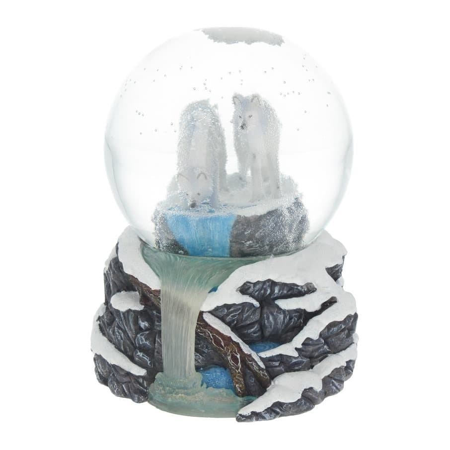 Snow globe with two wolves by a pool, on a stand of snow-covered rocks
