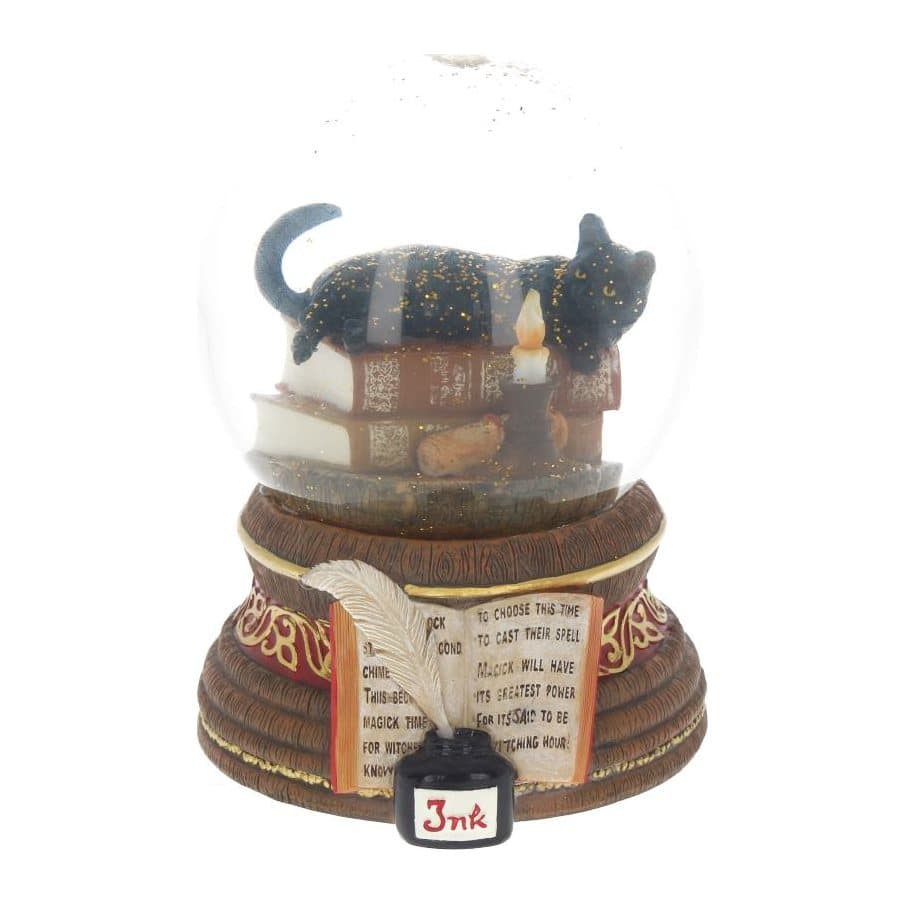 Snow globe with a black cat on occult books and a candlestick