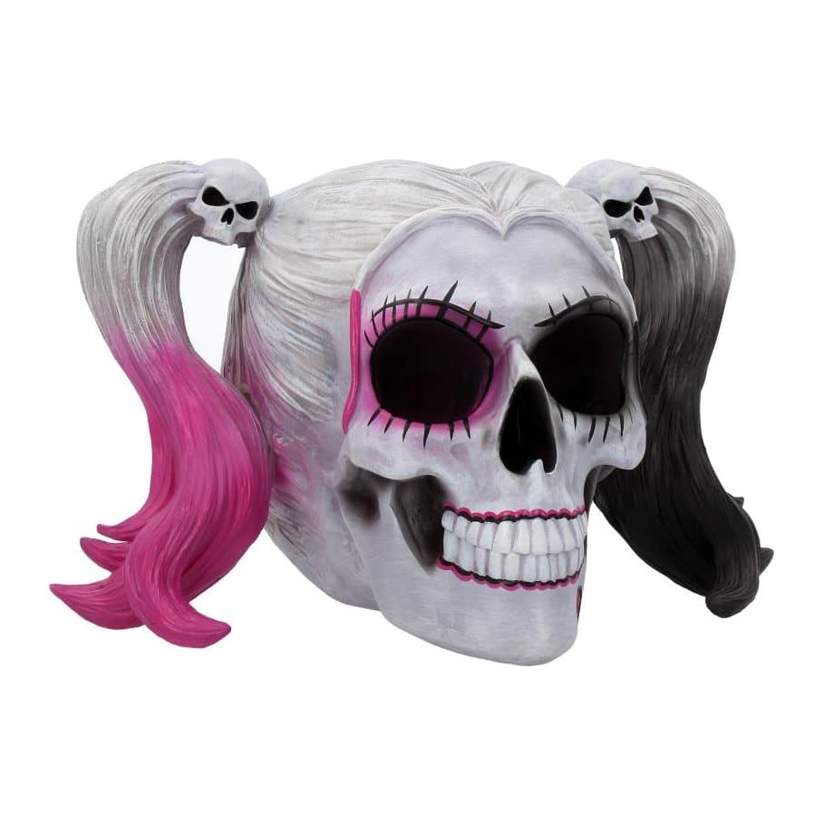 Skull figurine with white pigtails tipped pink and black and a pink heart on its chin