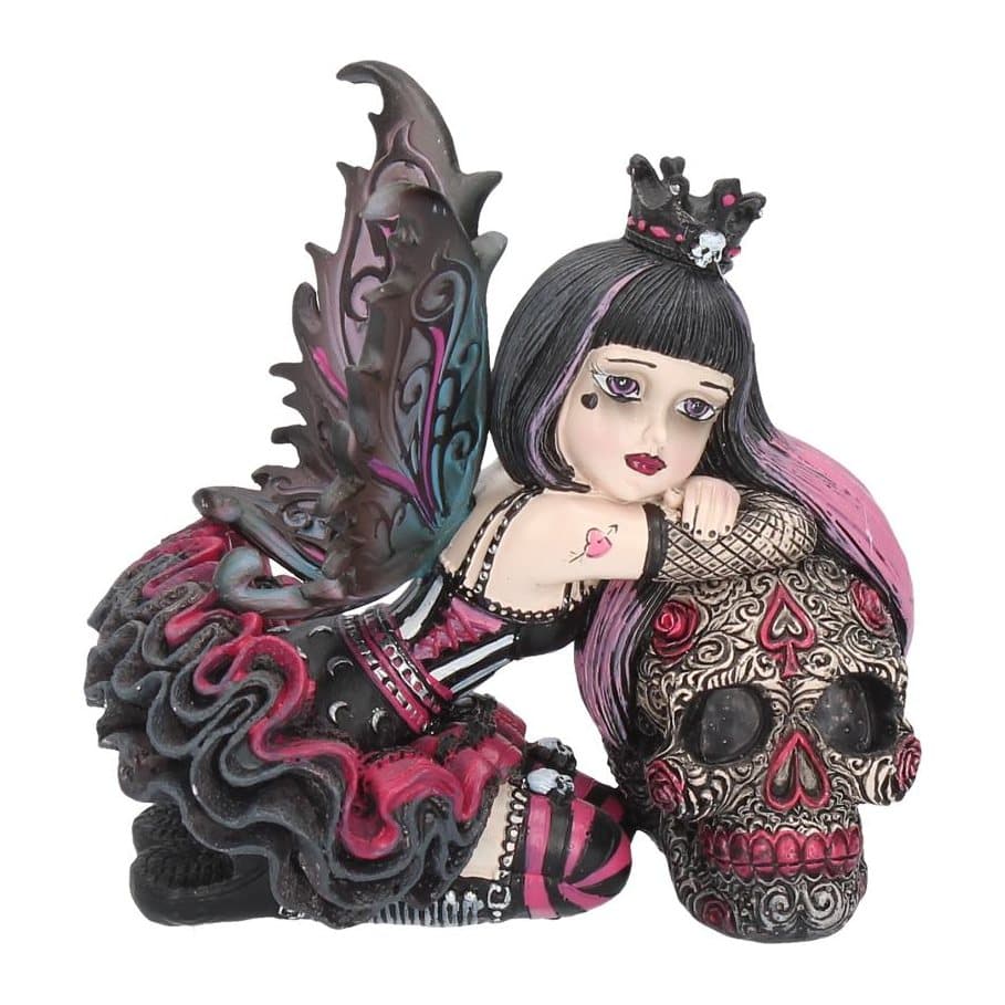 Gothic fairy with red and blue wings kneeling beside a painted skull