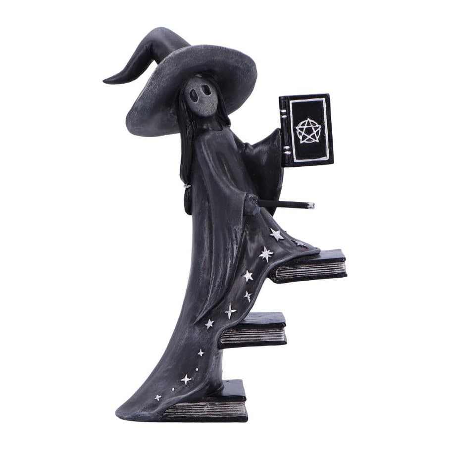 Black witch figurine climbing a floating staircase of spellbooks