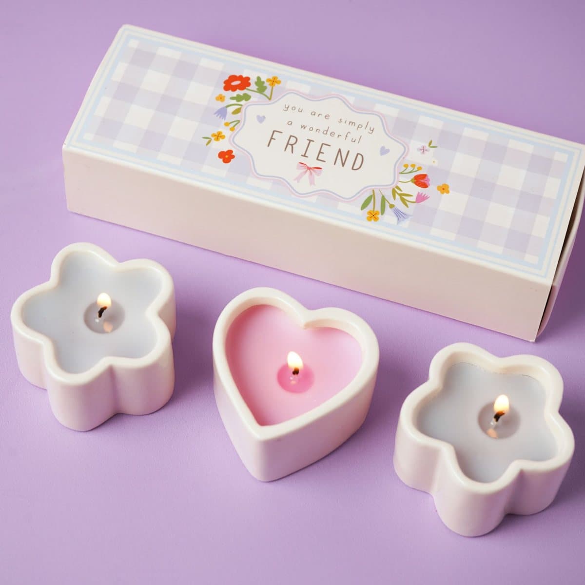 Three mini candles in heart and flower-shaped ceramic holders with patterned box