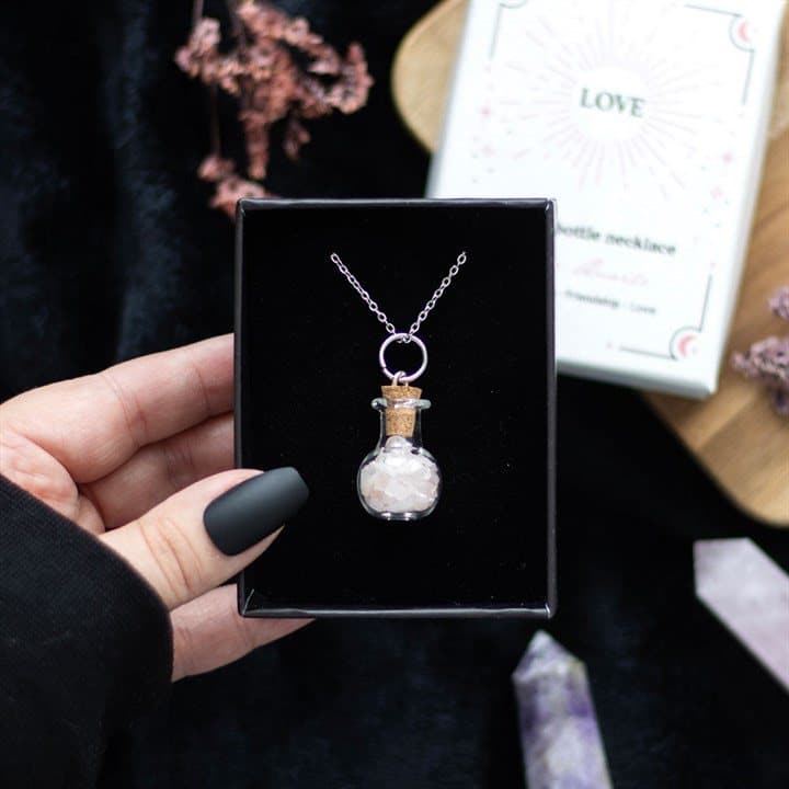 Miniature potion bottle necklace filled with rose quartz chips and a cork stopper