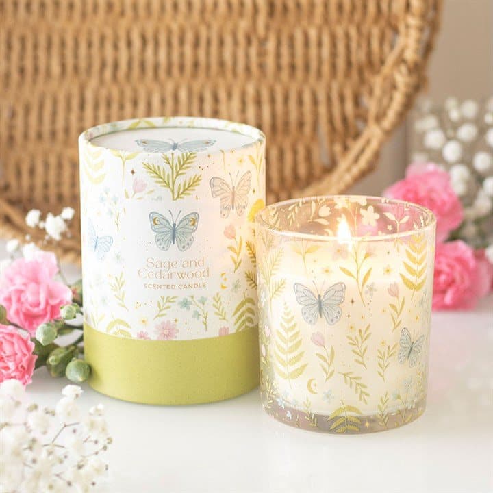 Sage and cedarwood candle in a glass holder with pastel florals and butterflies