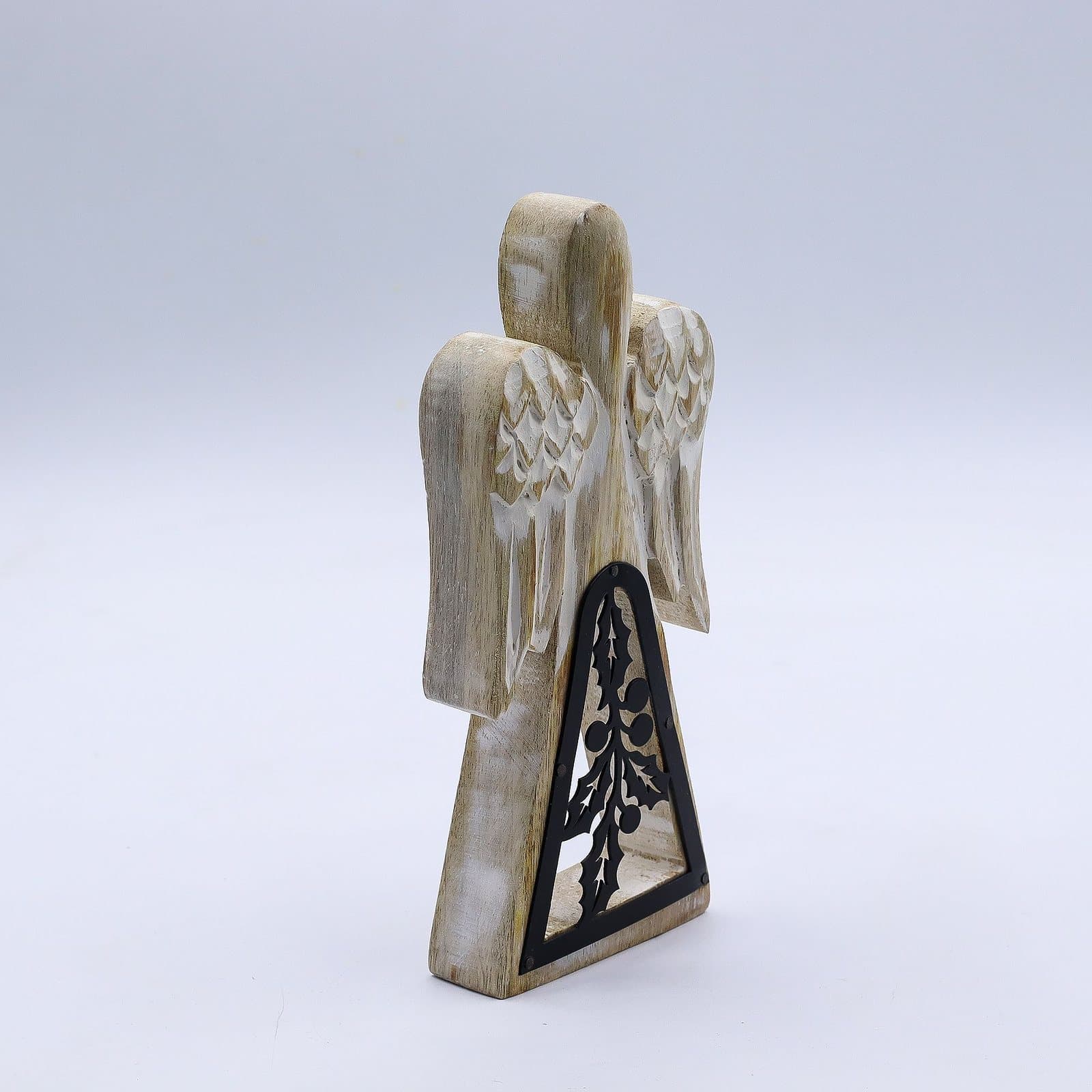 Whitewash mango wood angel with a dark iron holly cut-out in the skirt