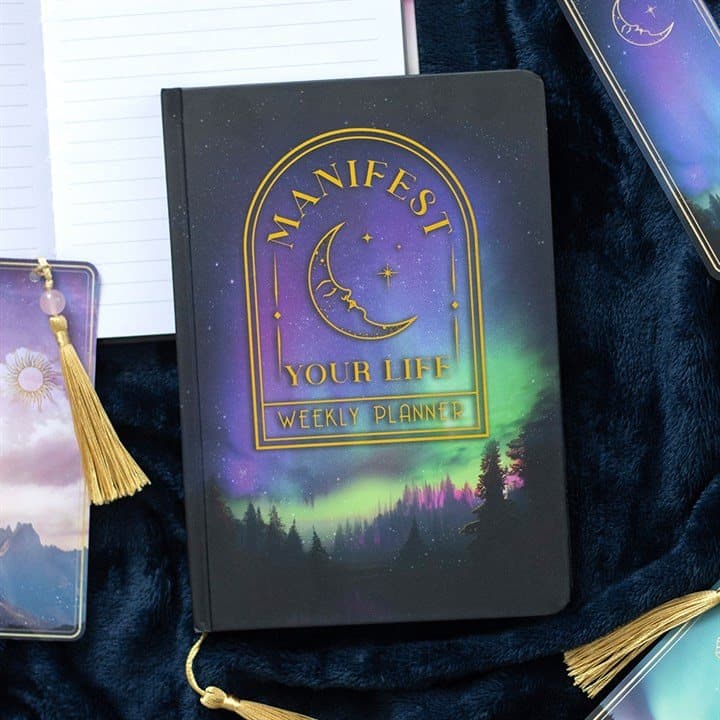A5 planner with a forest scene, gold foil moon and the words Manifest your life
