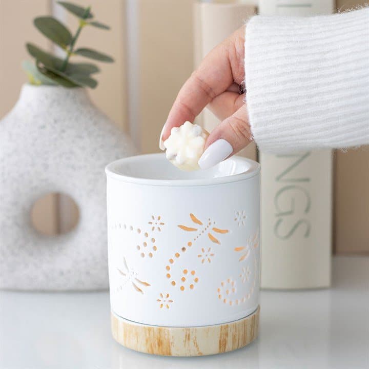 Matte ceramic oil burner with a dragonfly detail and wood-effect base