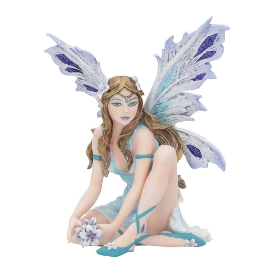 Resin fairy figurine with white wings sitting on the ground