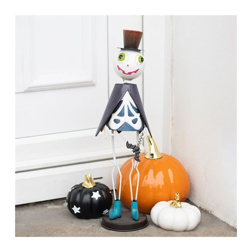 Metal skeleton ornament wearing a top hat and cape