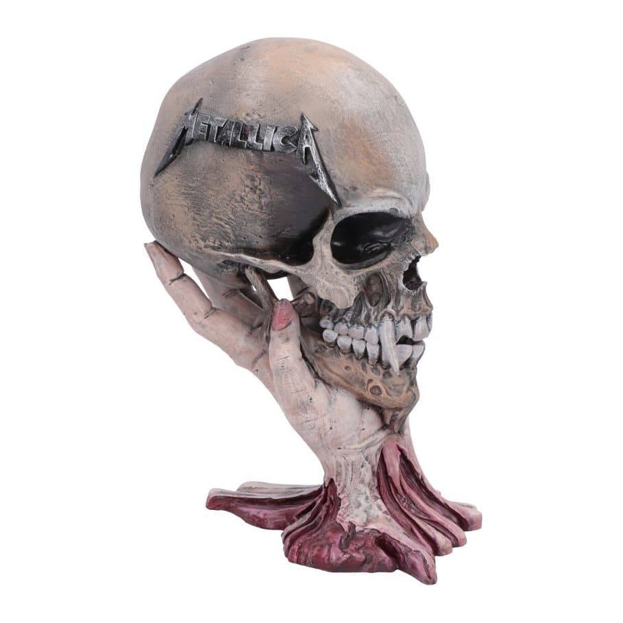 Hand-painted resin fanged skull held by a human hand with the Metallica logo