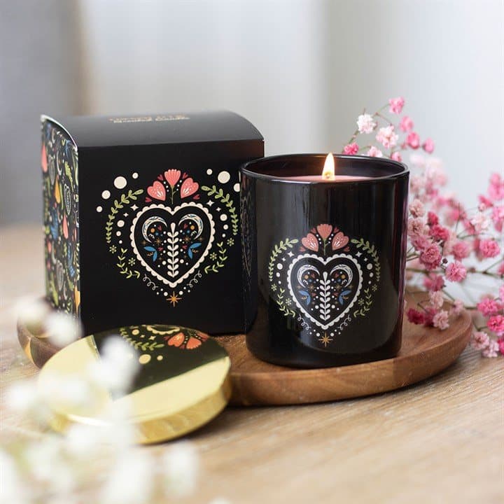 French Tulip scented candle in a sleek black glass jar with a folk heart design