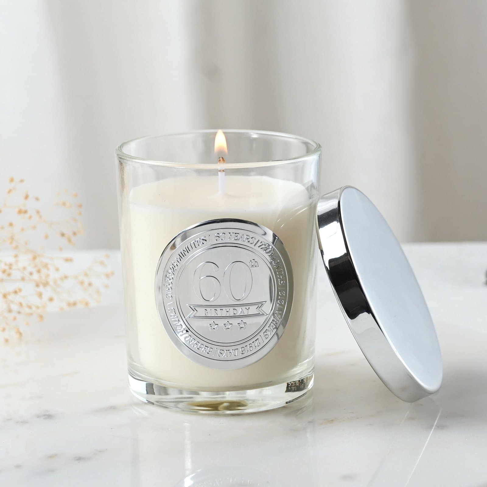 Sandalwood candle in a glass vessel with an embossed 60 seal and lid