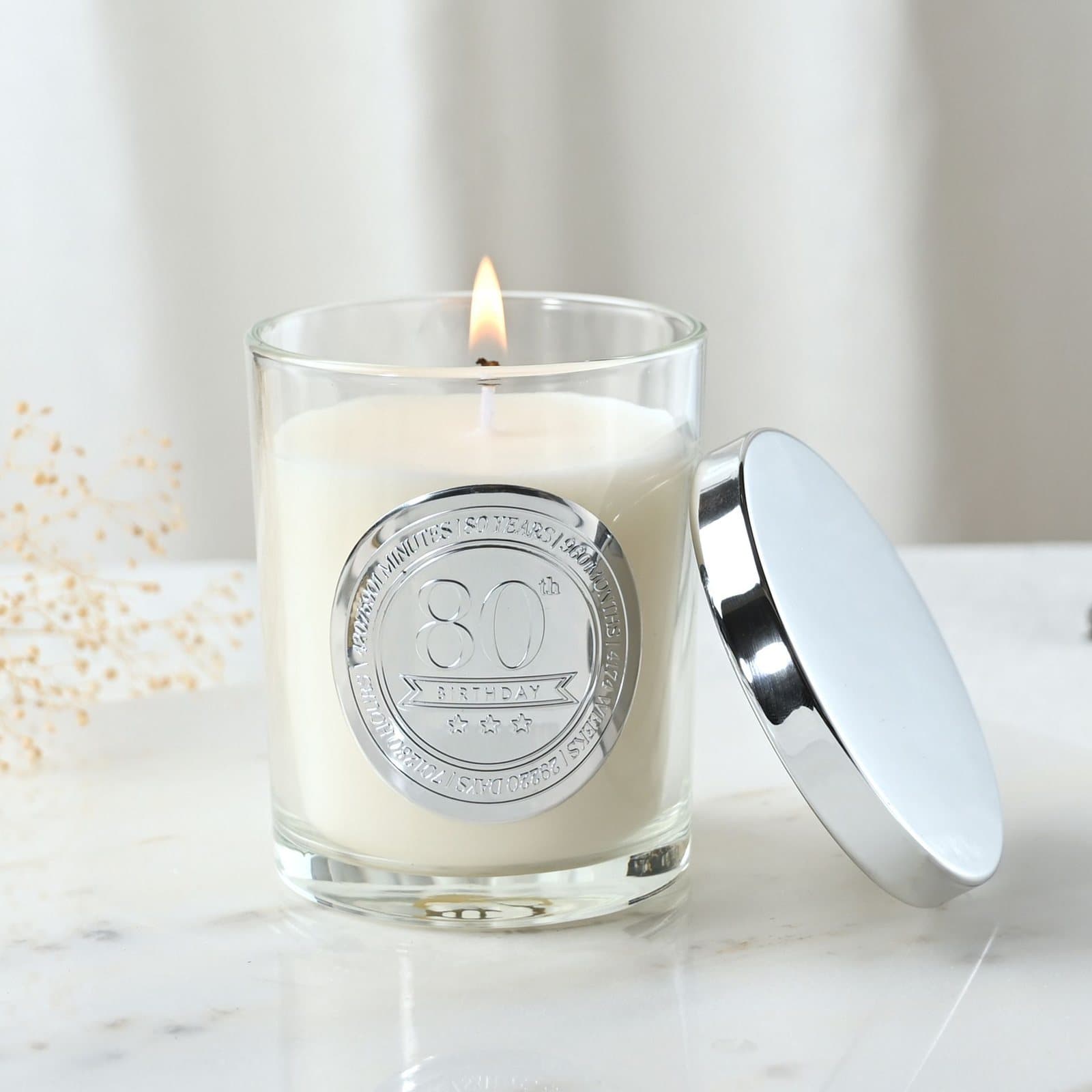 Sandalwood candle in a glass vessel with an embossed 80 seal and lid