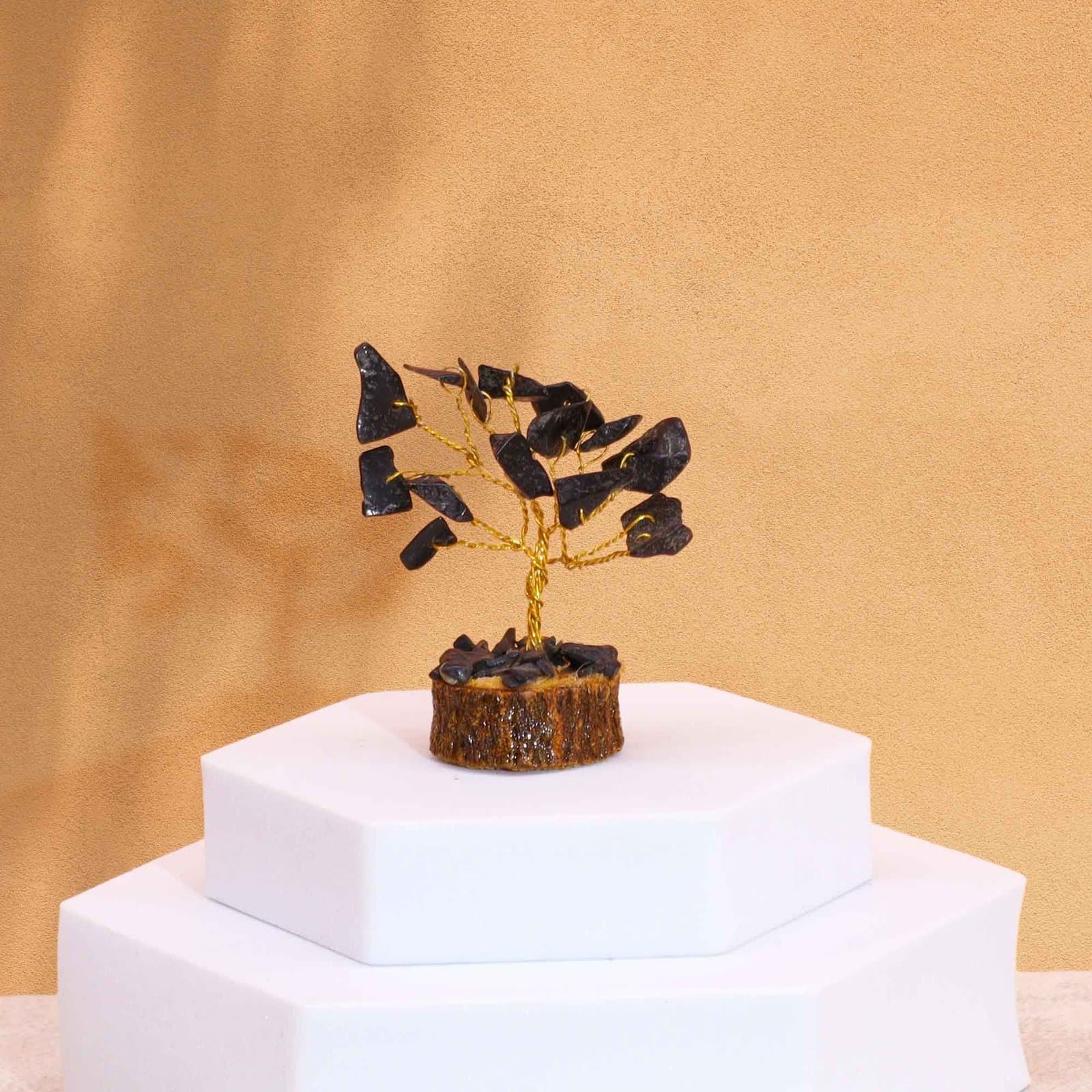 Mini gemstone tree of black agate stones on a wood base