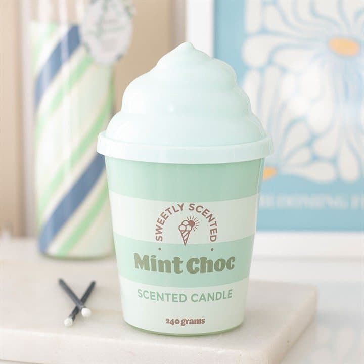 Mint green ice cream candle in a ceramic tub with a swirled silicone lid