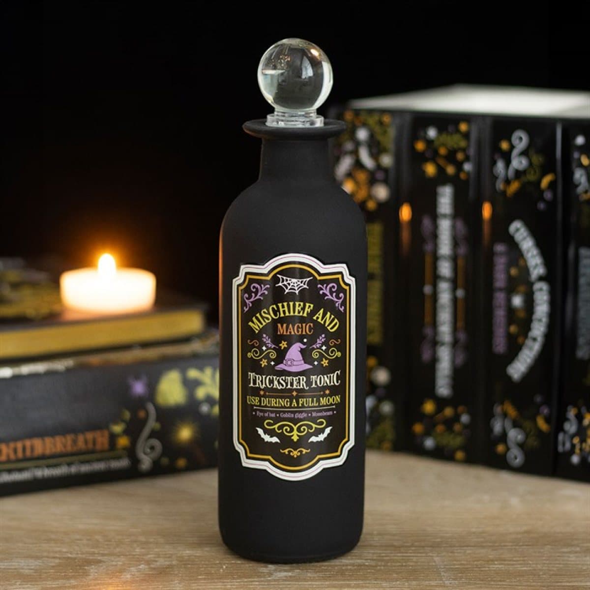 Glass potion bottle with a Mischief and Magic label and clear stopper