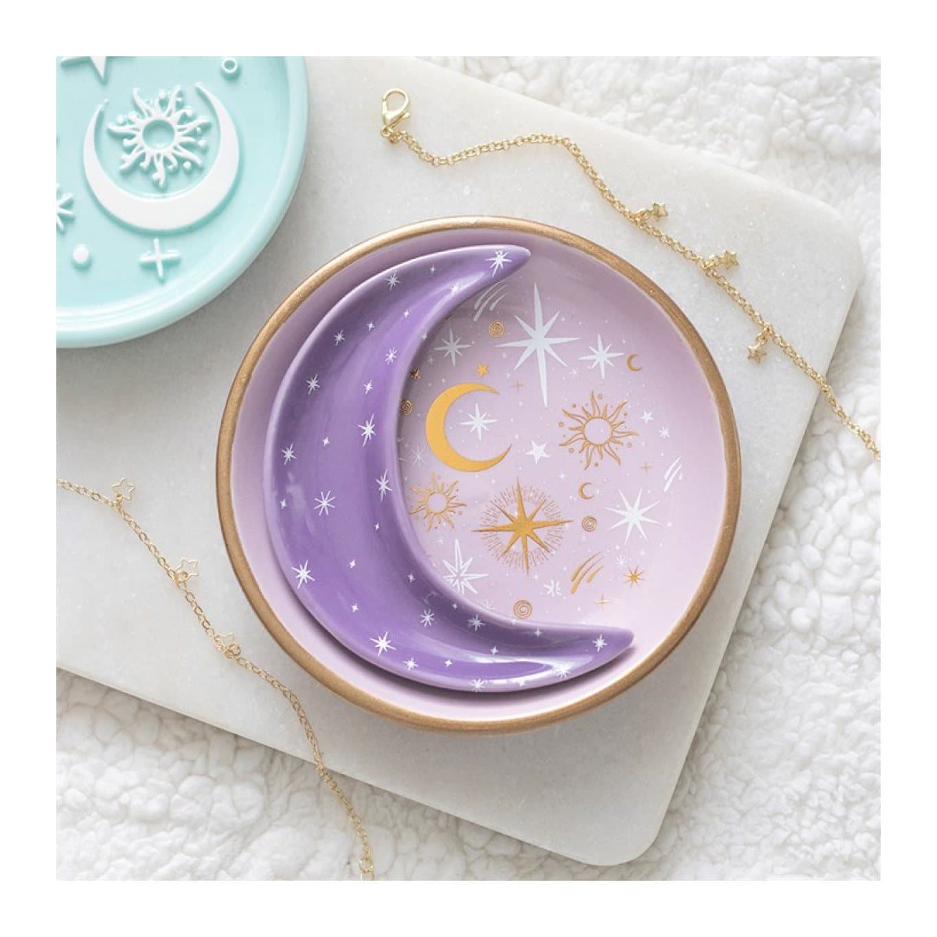 Purple ceramic trinket dish with gold moons and stars and a moon-shaped dish inside