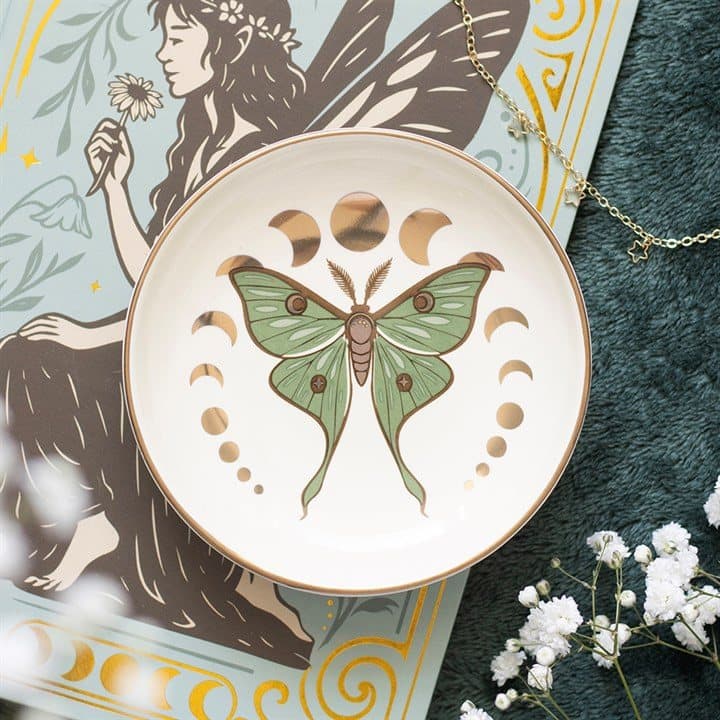 Round ceramic trinket dish with a green moth and metallic moon phase details