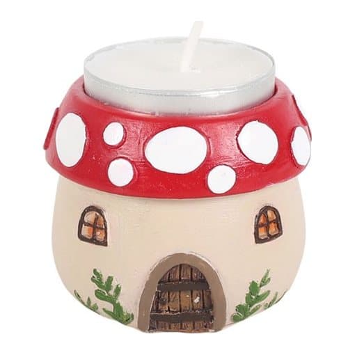 Resin tealight holder shaped as a mushroom house in a winter forest