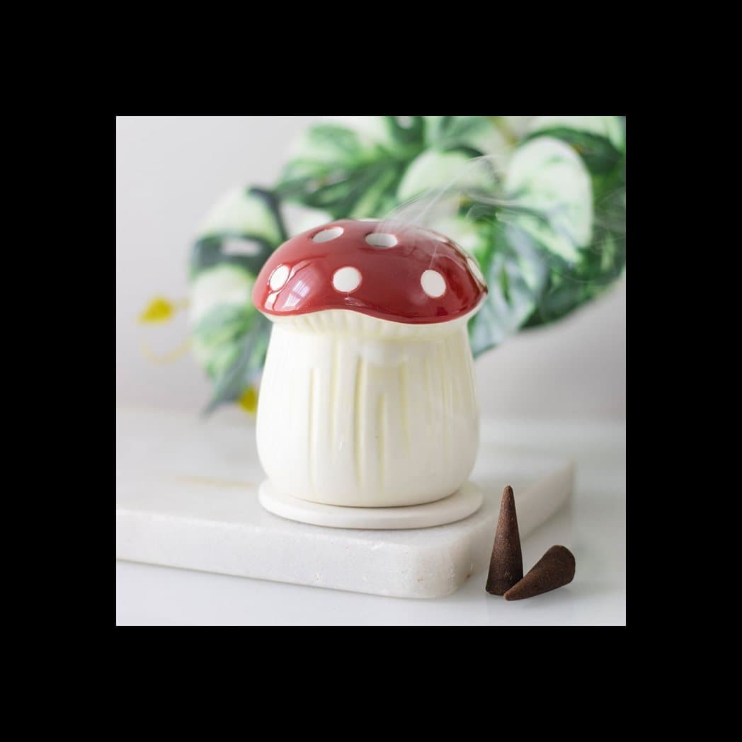 Ceramic incense cone holder shaped like a red mushroom