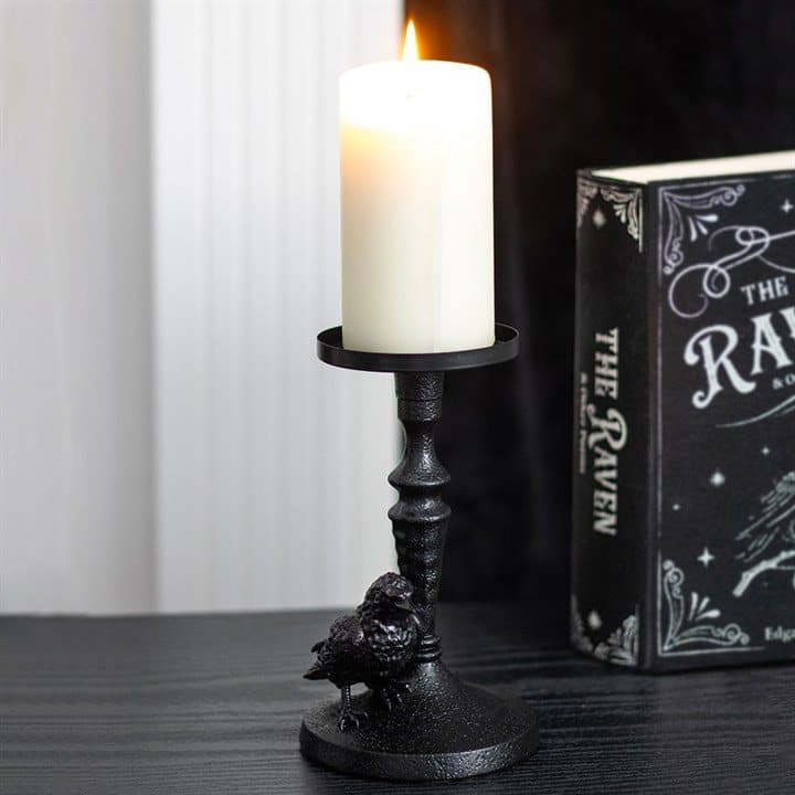 Resin raven perched on a gothic-inspired pillar candle holder base