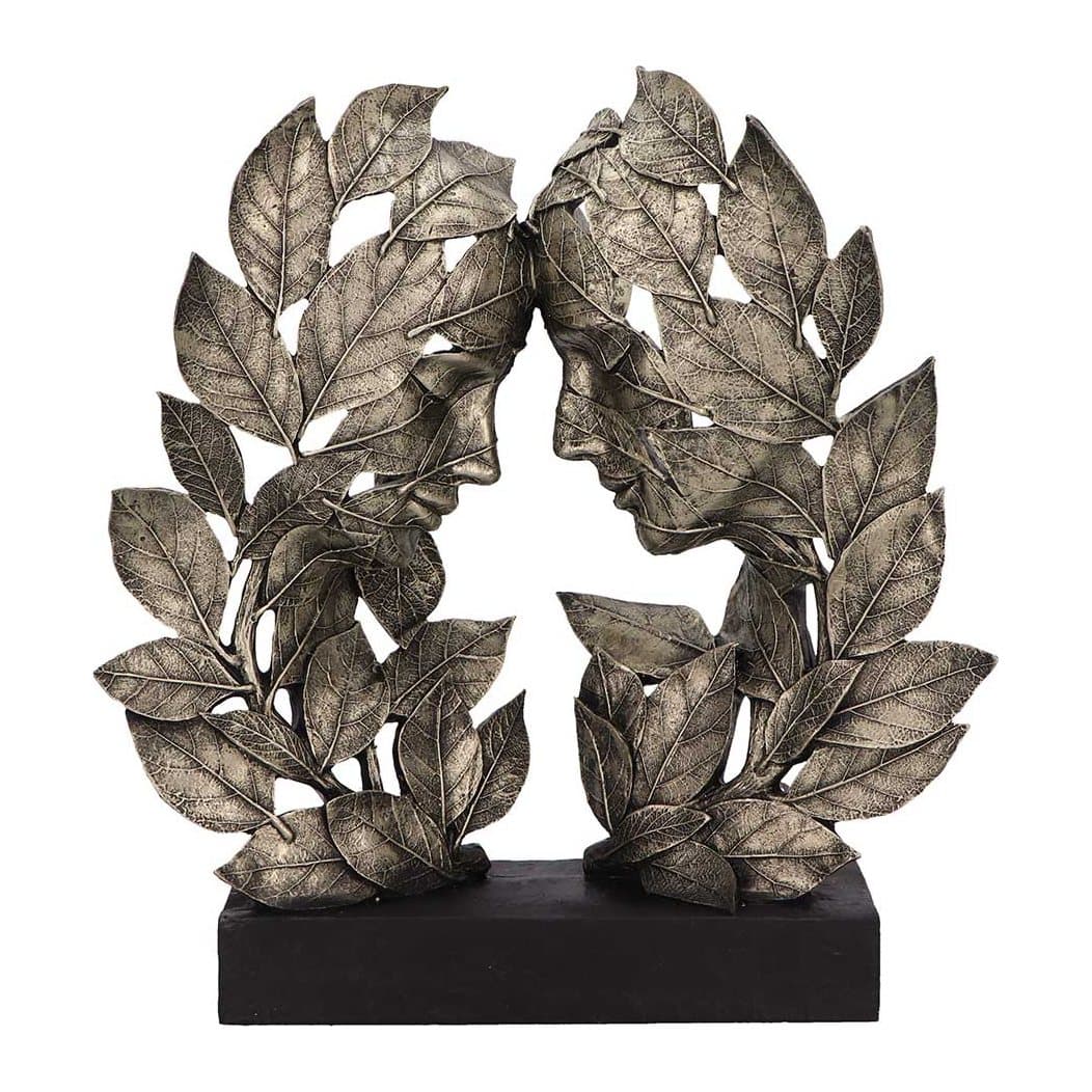 Silver resin statue of two leaf-formed heads touching foreheads on a black base
